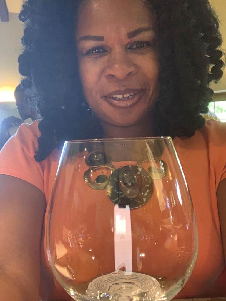 A woman holding a glass of wine.