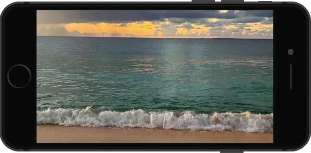 An iphone displaying a beach scene with waves.